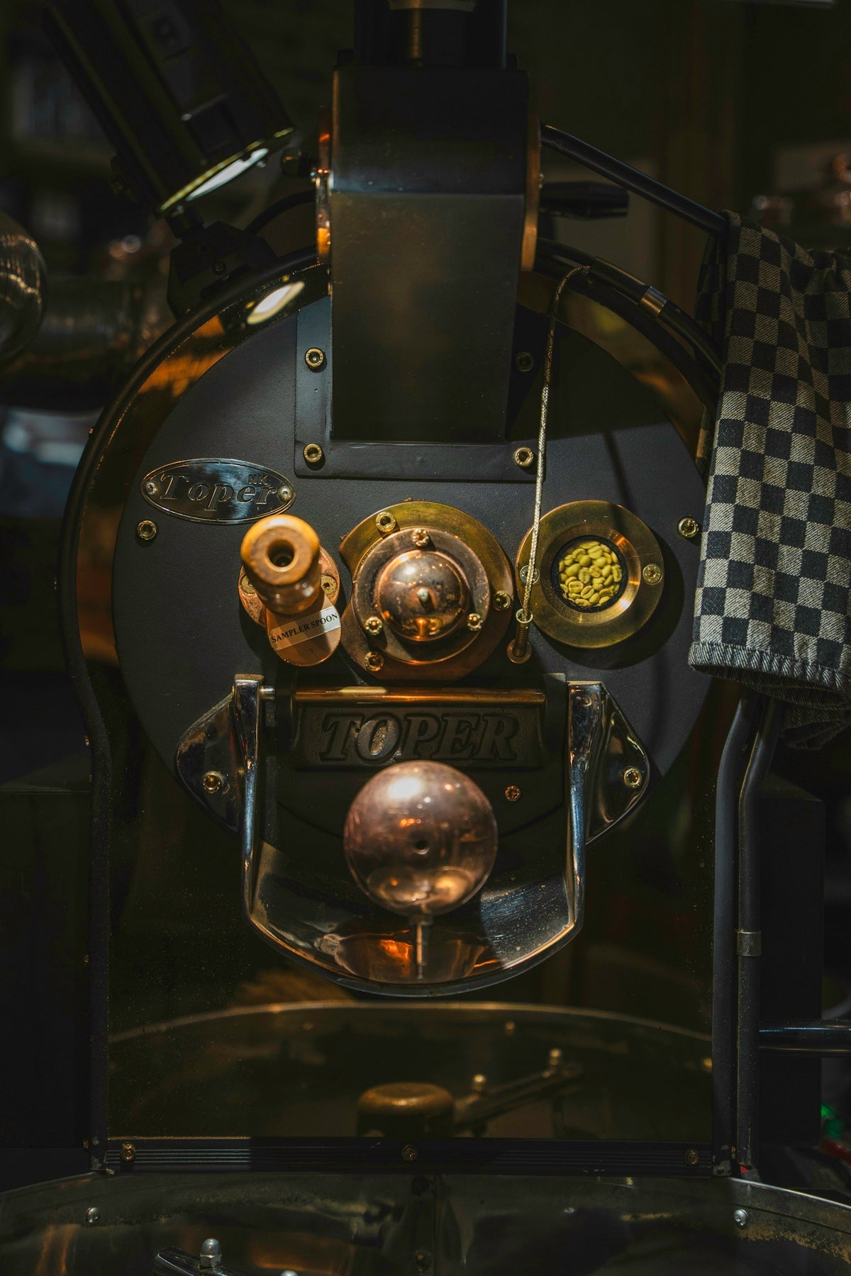 A close up of a machine with a checkered cloth on it