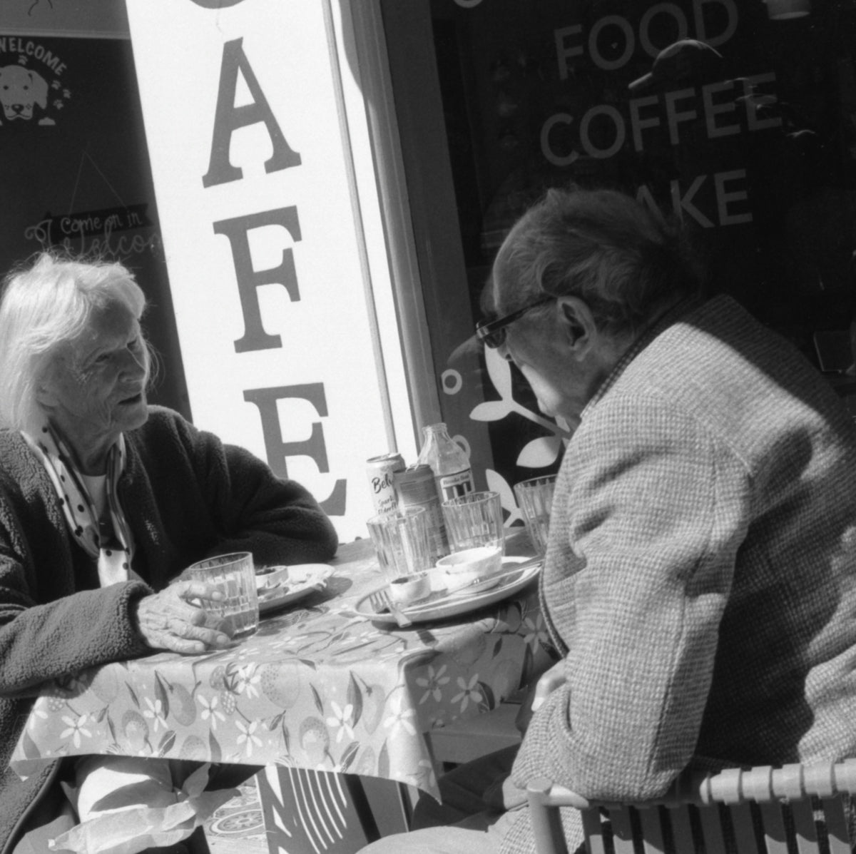 Elderly couple sitting at a cafe table